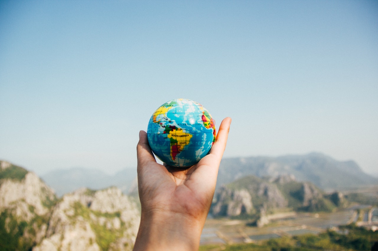 a person holding a small globe