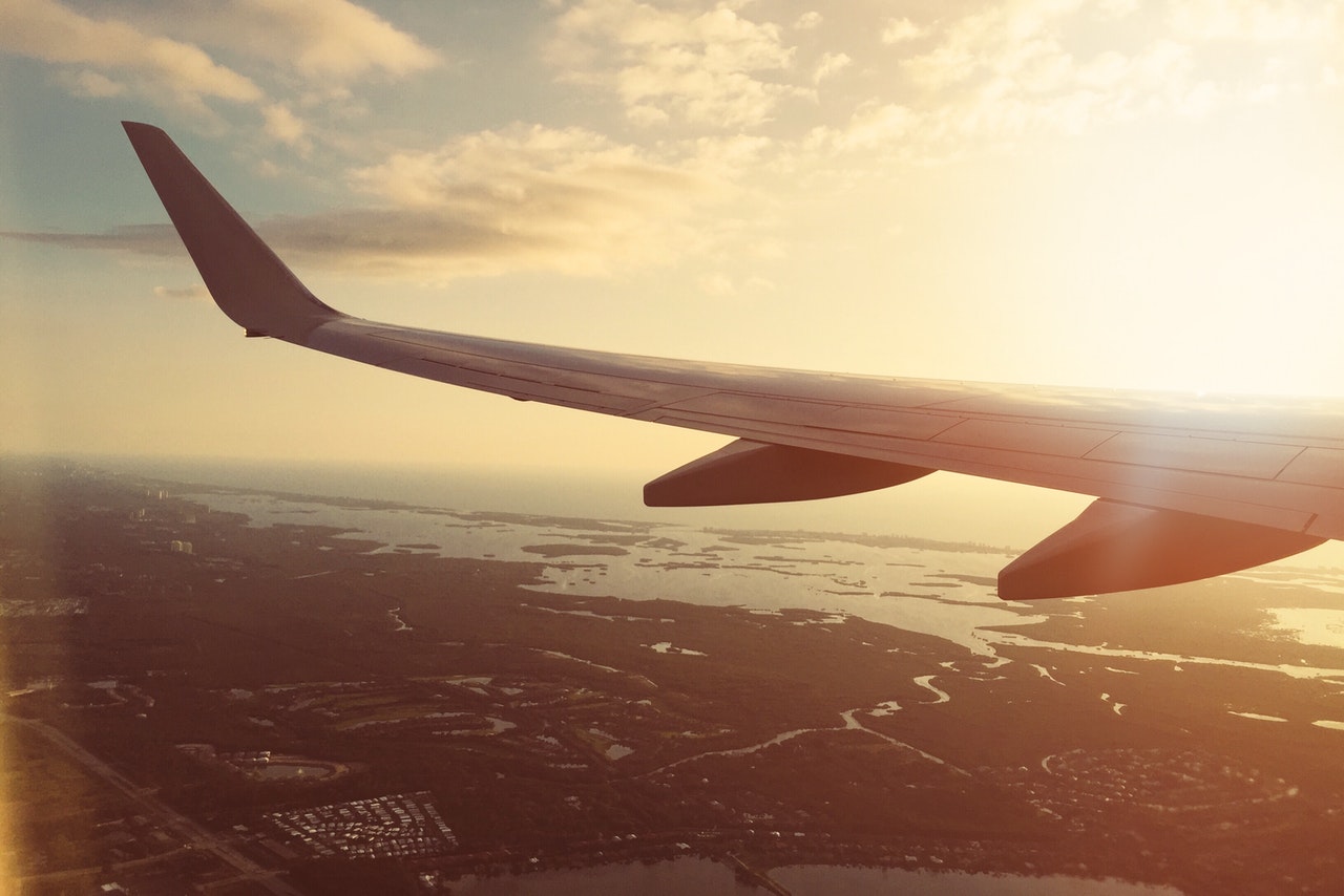 a plane wing above the sea